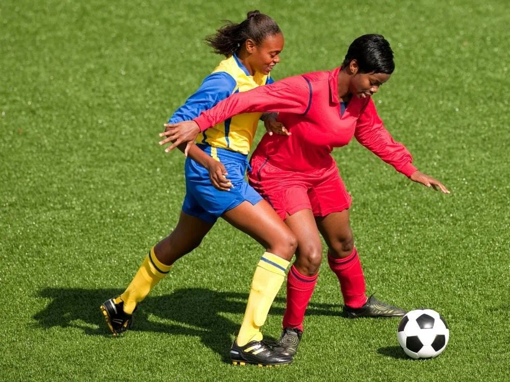 Soccer defender holding off an attacker