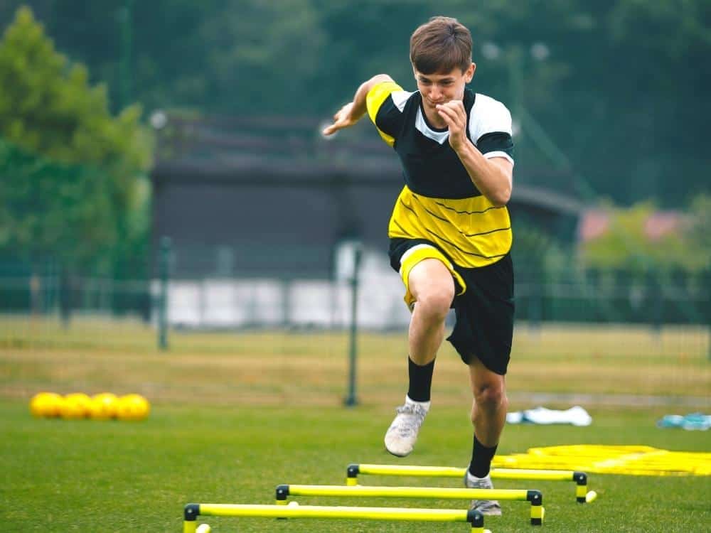 Soccer player running on ladders in training