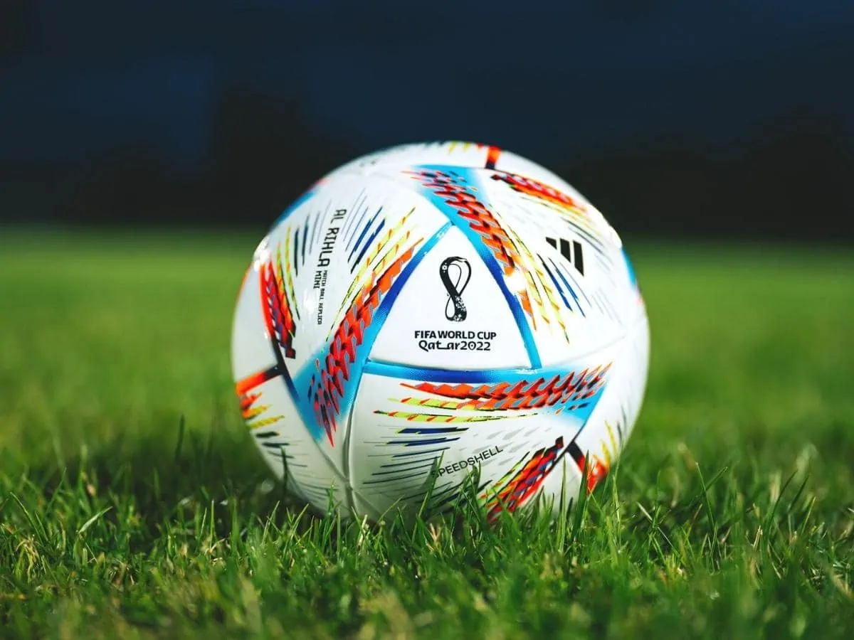 Official Adidas Fifa World Cup Football Ball Al Rihla. World Championship in Qatar 2022. Soccer Match Ball on green grass in night at Stadium. FIFA 22. ○ Soccer Blade