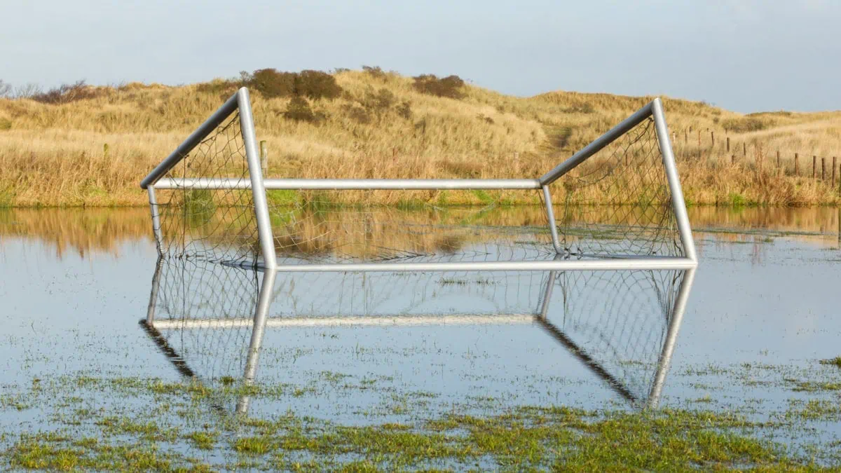 Flooded soccer field with goal fallen. ○ Soccer Blade