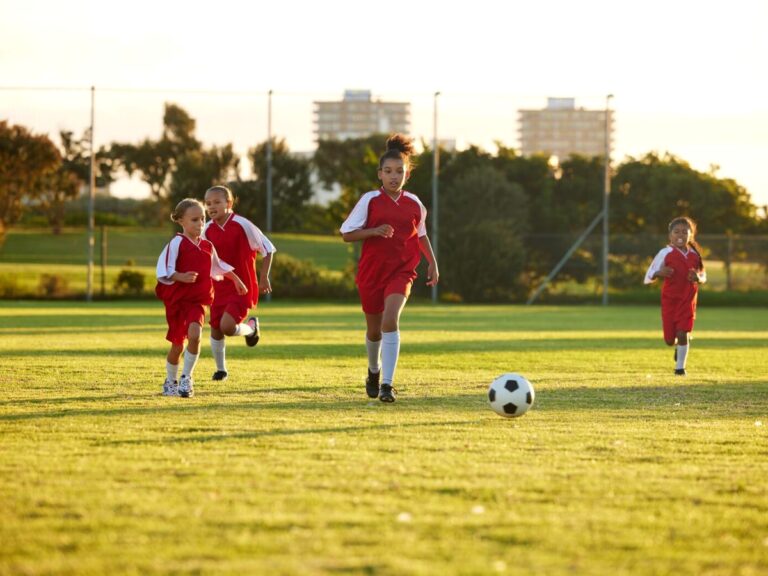 Youth soccer players of different ages running after a ball. ○ Soccer Blade