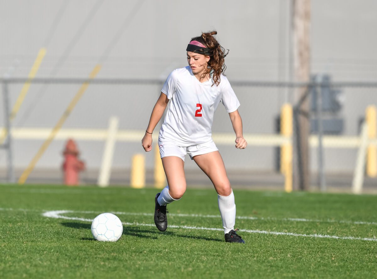 Young female soccer player turning with the ball ○ Soccer Blade