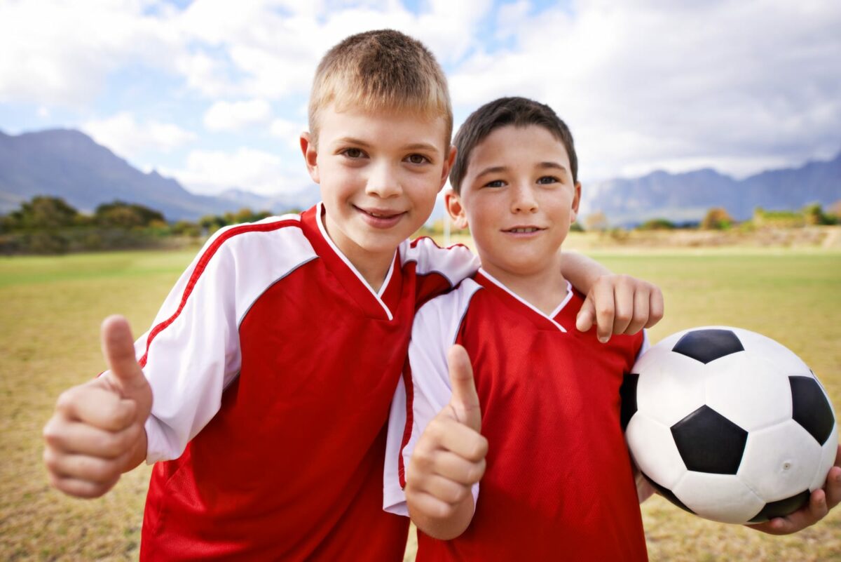Were up for the game. two kids standing on the soccer field ○ Soccer Blade