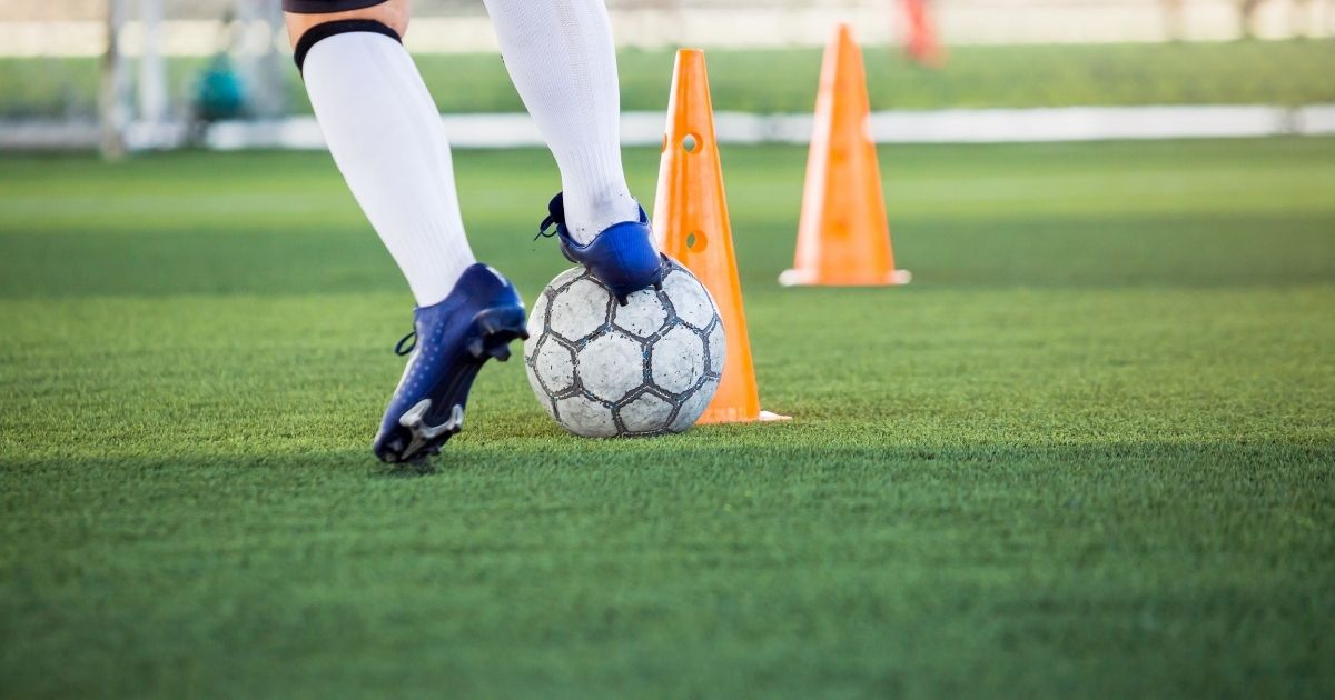 Foot on a soccer ball next to a cone ○ Soccer Blade